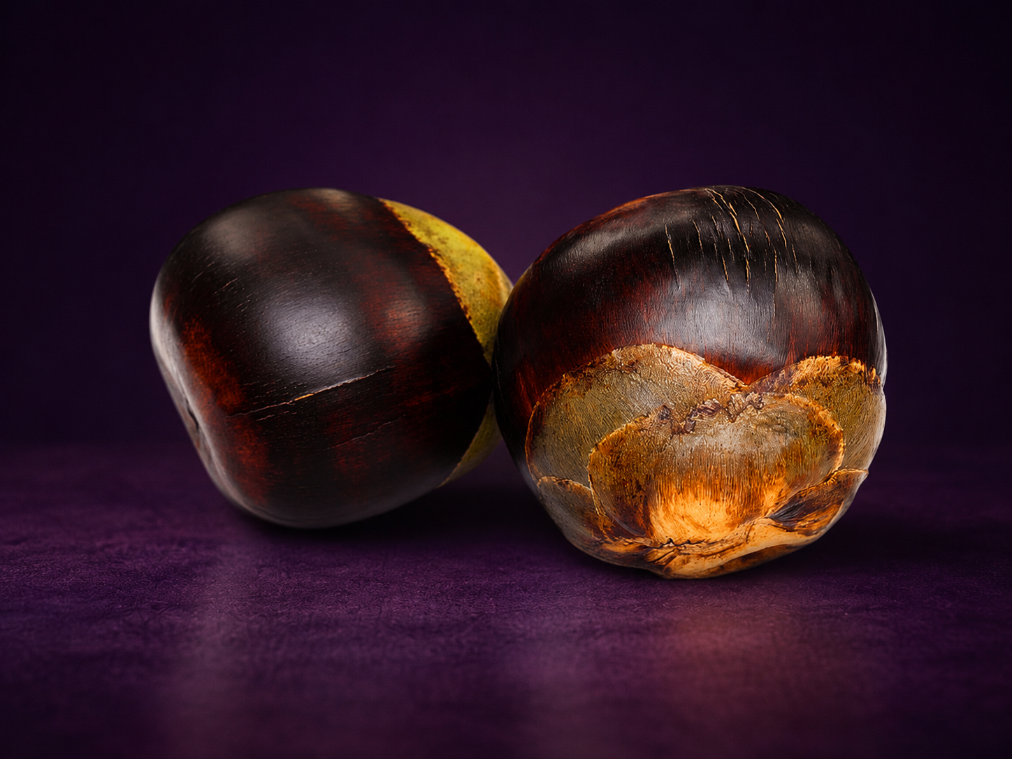 Two whole Nungu (ice apple) fruits on brand purple background